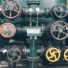 engineer inspecting industrial valve - home intro